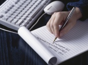 Person writing on a notepad